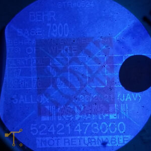 Closeup picture of a faded thermal label under a 365nm blacklight.